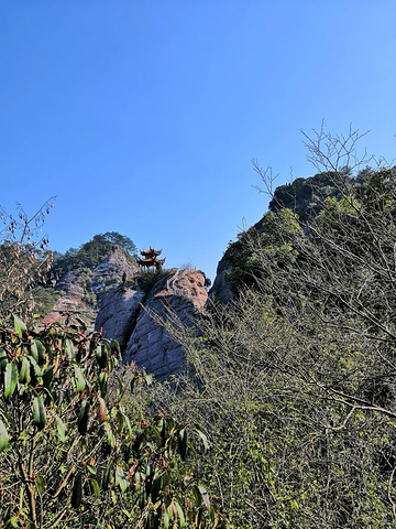 "冠豸山风景区属丹霞地貌，苍玉峡逶迤而入，一石若悬，流泉从石间穿过，潺潺不断，逾半山处，巨石之上..._冠豸山国家级风景名胜区"的评论图片